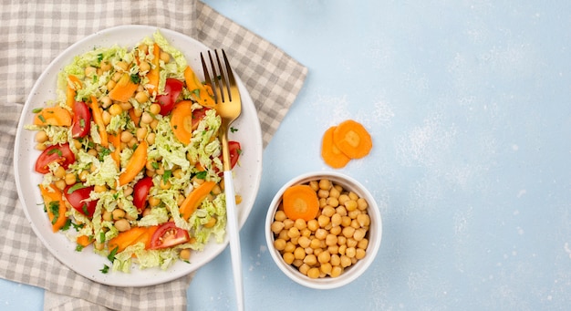 Top view salad with chickpeas, carrots and copy-space