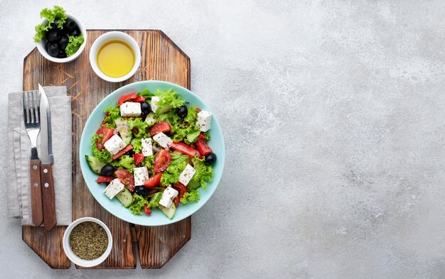 Top view salad with feta cheese on cutting board with copy-space