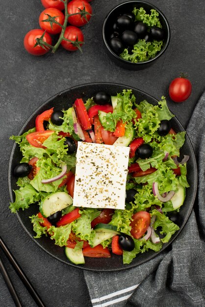 Top view salad with feta cheese, tomatoes and olives