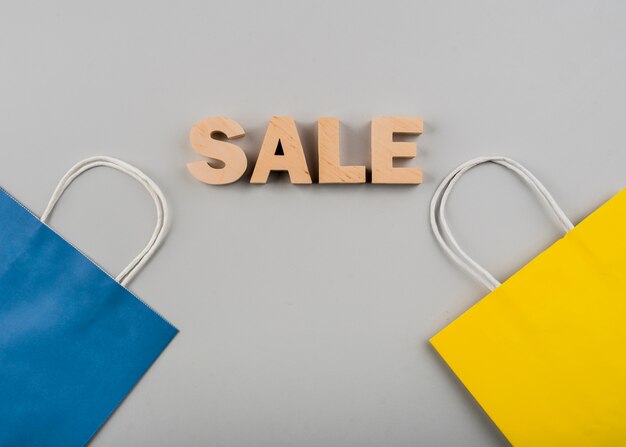 Top view of sale letters with yellow and blue bag