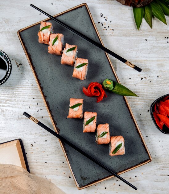 Free Photo | Top view of salmon sushi topped with cream and onion slice