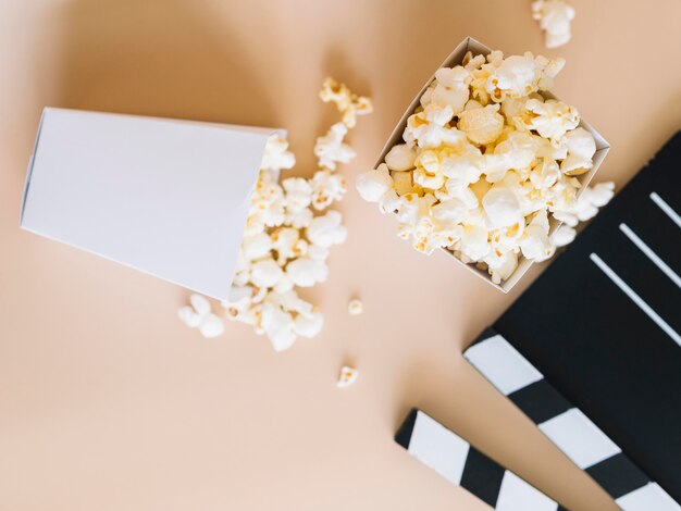 Top view salted popcorn with clapperboard