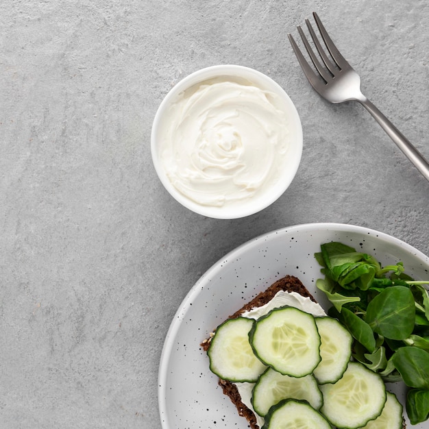 Top view sandwich with cucumbers on plate with fork