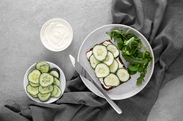 Top view sandwich with cucumbers on plate with knife