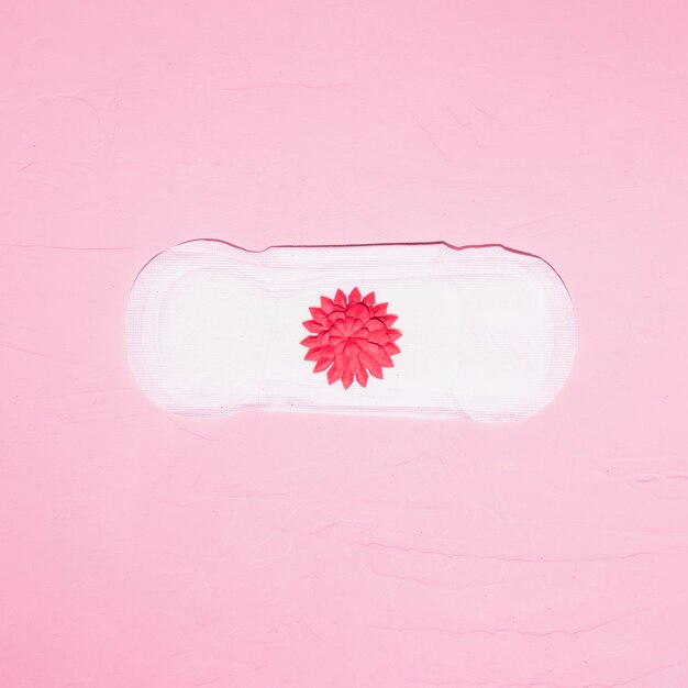 Top view sanitary towel with paper flower