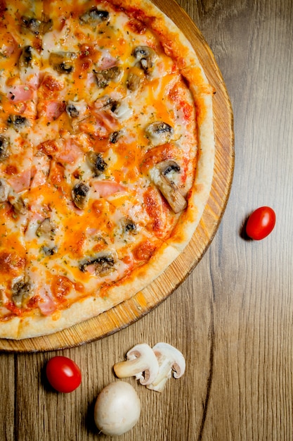 Top view of sausage pizza with mushroom tomato and cheese