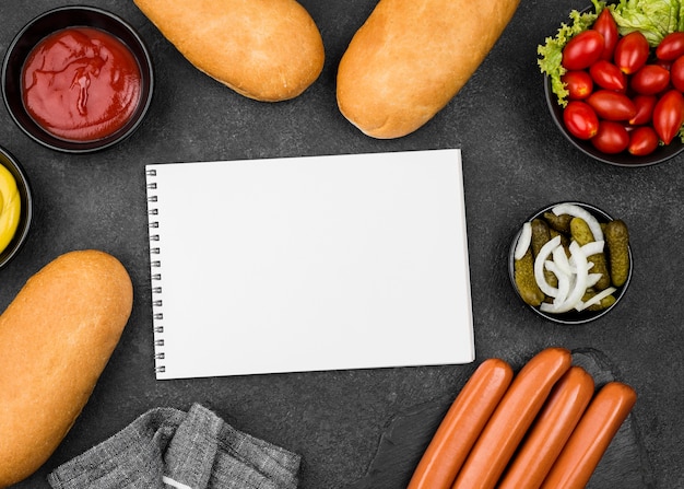 Top view sausages, buns and tomatoes