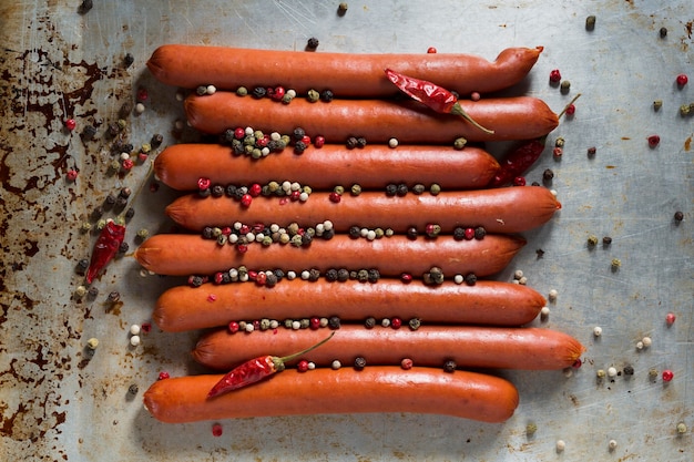 Top view sausages with pepper on tray