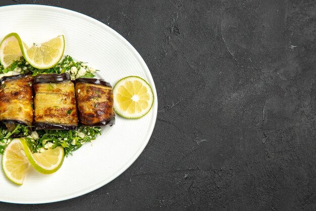 Top view savory eggplant rolls with lemon slices on dark surface fruits cooking meal dinner dish