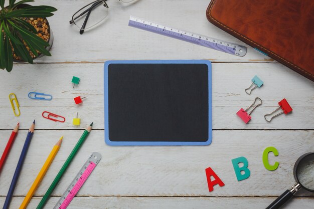 top view school elements on wooden background