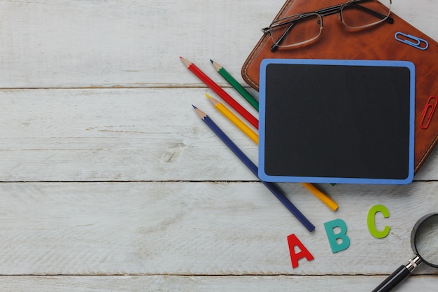 top view school elements on wooden background