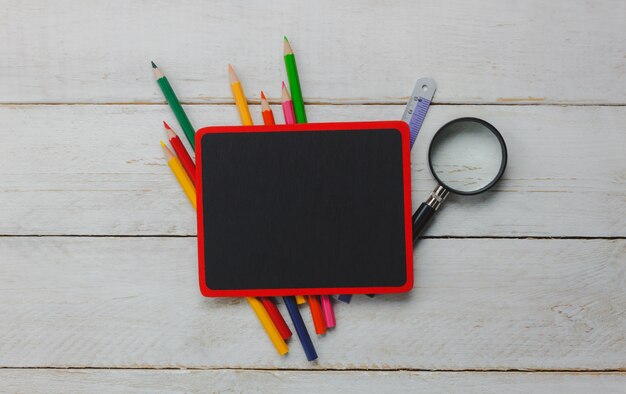 top view school elements on wooden background