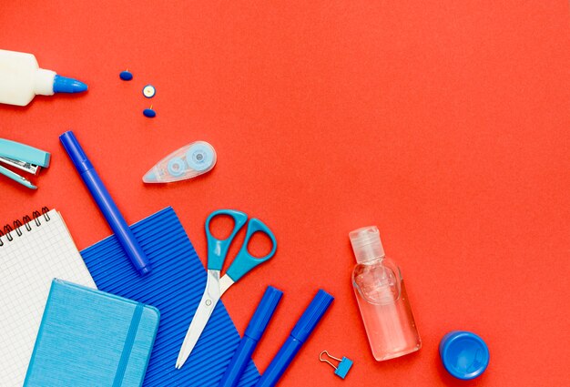 Top view school items on red background