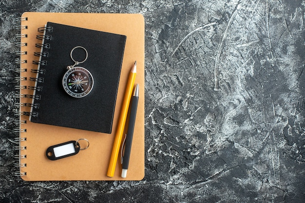 Top view of school supplies on dark surface