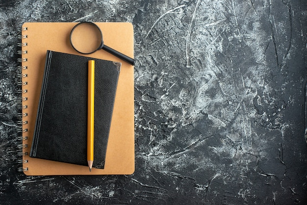 Top view of school supplies on dark surface