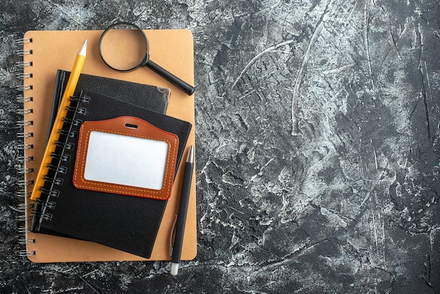 Top view of school supplies on dark surface