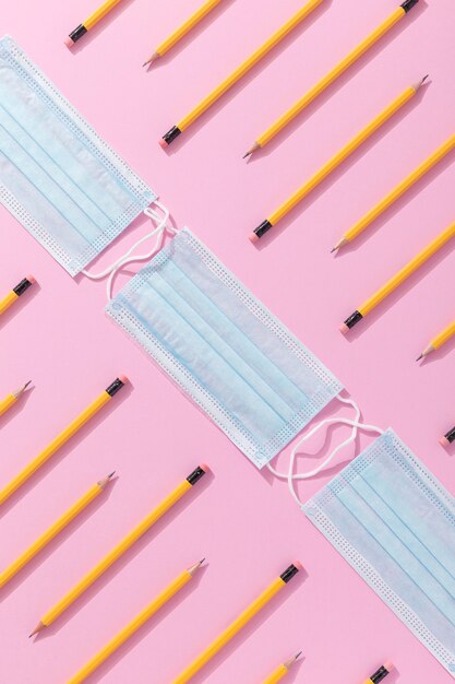 Free photo top view of school supplies with face mask and pencils