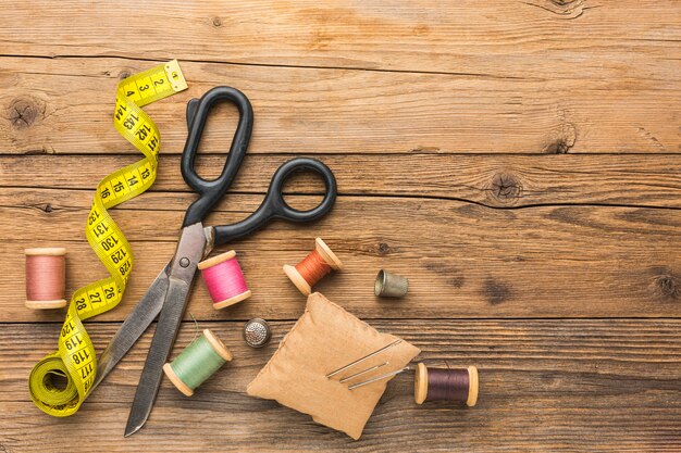 Top view of scissors with measuring tape and copy space