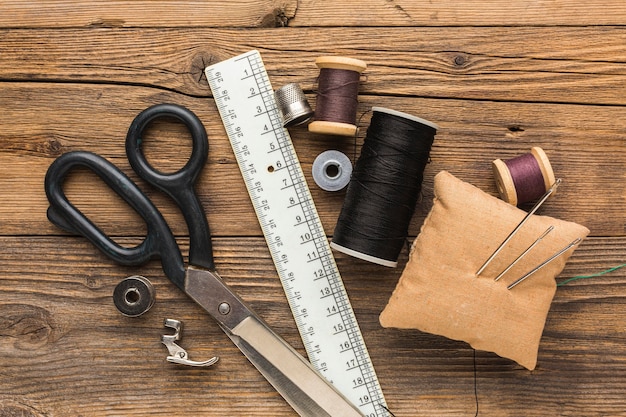 Top view of scissors with needles and thread