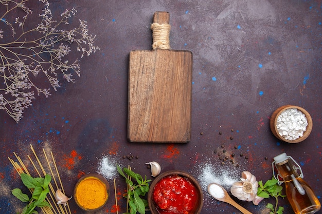 Top view seasonings and sauce on a dark background meal spicy hot food color