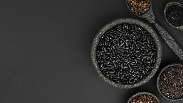 Top view of seeds and condiments in bowls with copy space