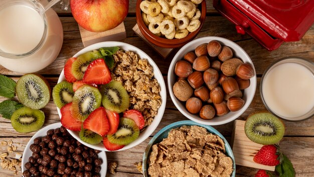 Top view of selection of breakfast cereals in bowl with fruits