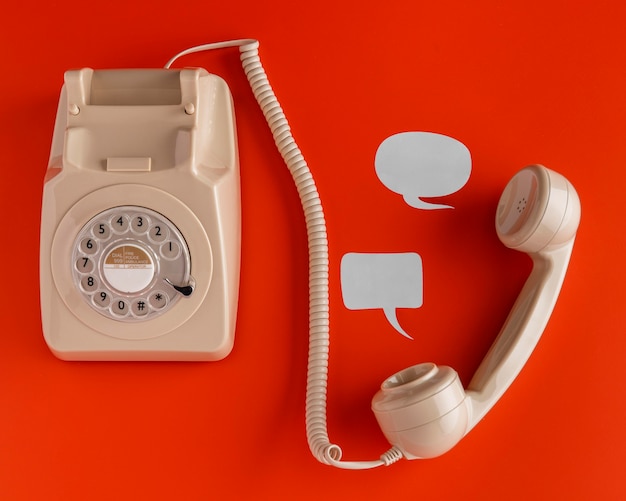Top view of selection of chat bubbles with retro telephone