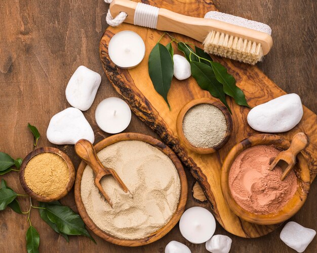 Top view of selection of fine powders in bowls with scoops and stones