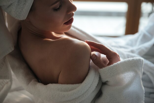 Top view of a sensual young woman in bathrobe posing