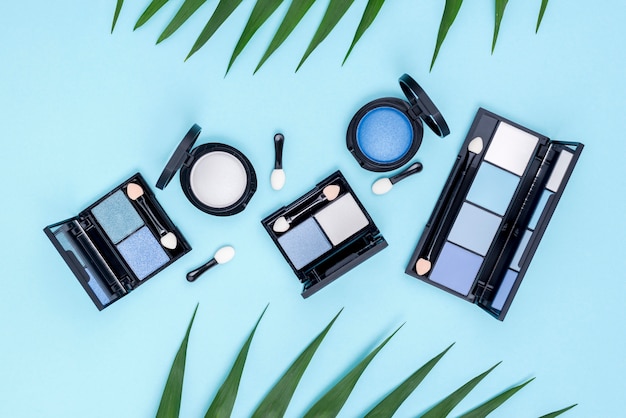 Top view set of beauty products on blue background