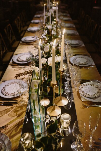 Top view of the set table decorated with flowers and candles