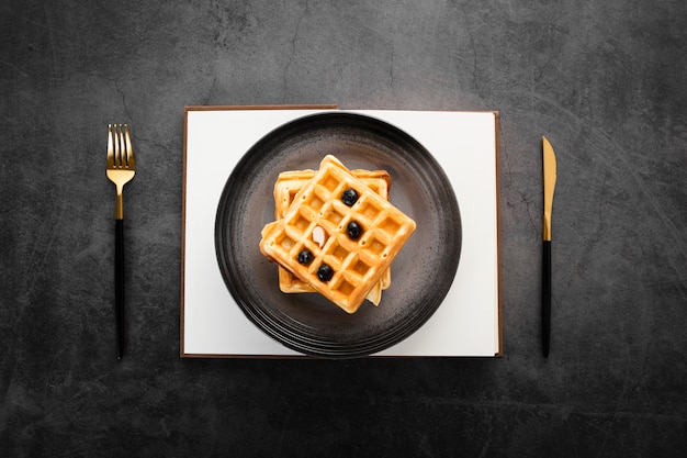 Top view set of two waffles with gold cutlery