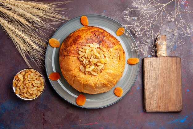 Top view shakh plov delicious eastern meal consists of cooked rice inside round dough on a dark surface food cuisine meal rice cooking