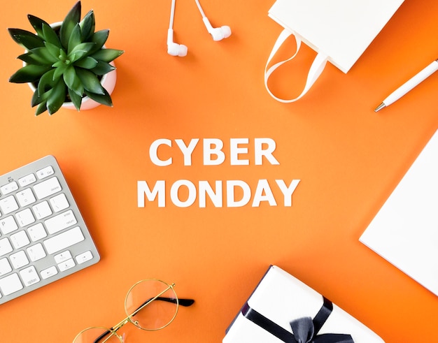 Top view of shopping bag with gift and keyboard for cyber monday