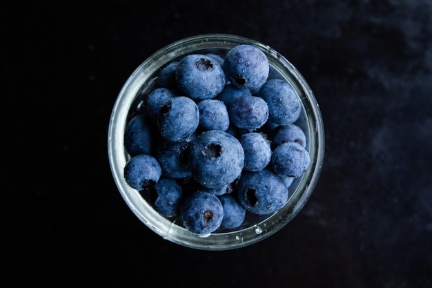 Top view shot of blueberries in a glass bowl