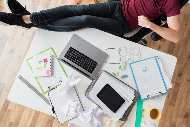 Top view shot of guy sitting next to a desk