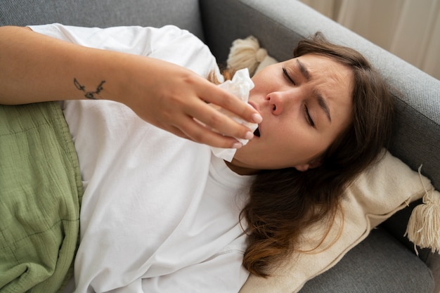 Top view sick woman on couch at home