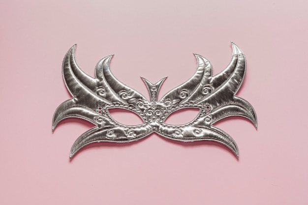 Top view silver mask on pink background