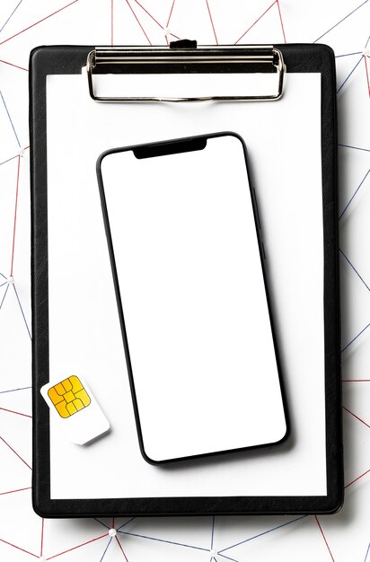 Top view of sim card with smartphone and clipboard