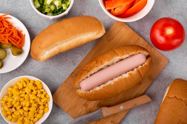 Top view of simple hot dog with tomatoes and corn