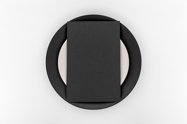 Top view of simplistic blank menu paper on plate