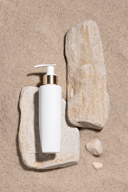 Free photo top view skincare product on the beach