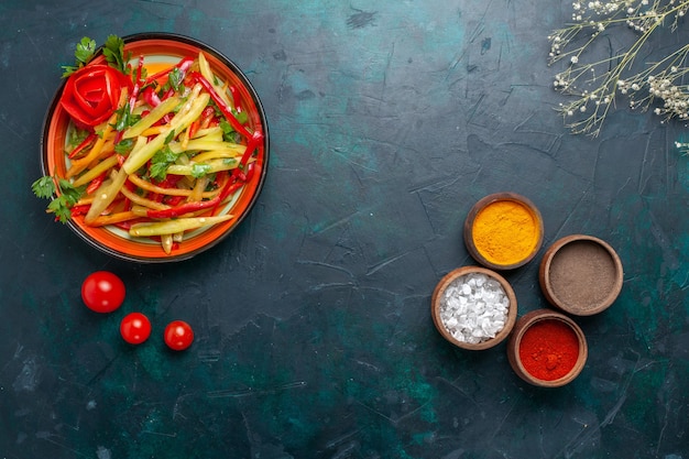 Top view sliced bell peppers healthy salad with different seasonings on blue background