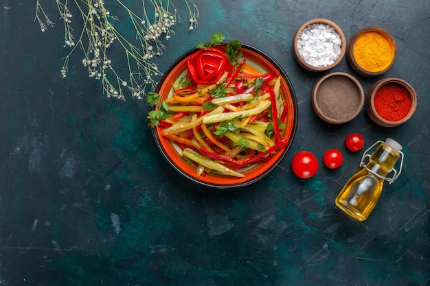 Top view sliced bell-peppers tasty healthy salad with seasonings and olive oil on dark background