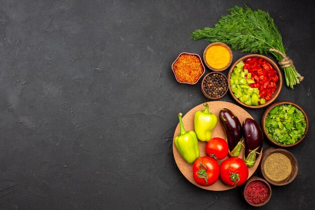 Top view sliced bell-peppers with greens and vegetables on dark surface product meal food salad health