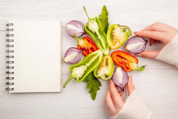 Top view sliced bell-peppers with onions on white table