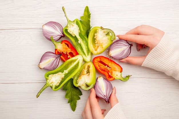 Top view sliced bell-peppers with onions on white table