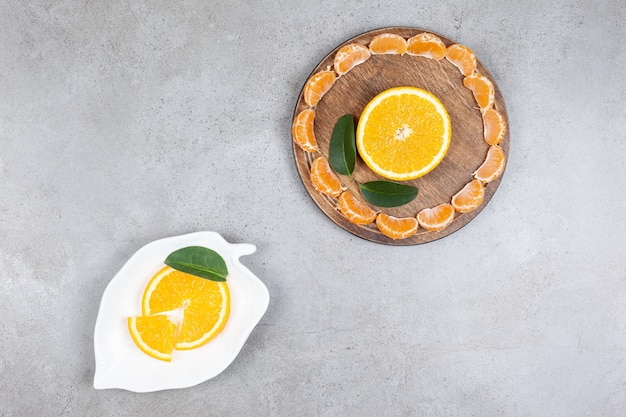 Top view of sliced citrus fruits . Tangerine and orange slices.