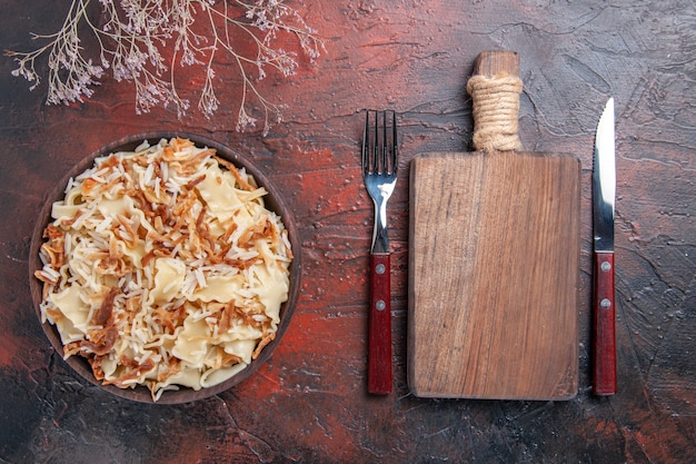 Top view sliced cooked dough with rice on dark desk meal pasta dish dough