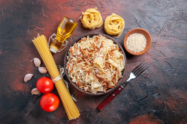 Top view sliced cooked dough with rice on dark surface pasta dish dough